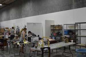 Artist participants help organize the new space.