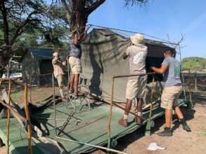 The team trying to rebuild a damaged tent.