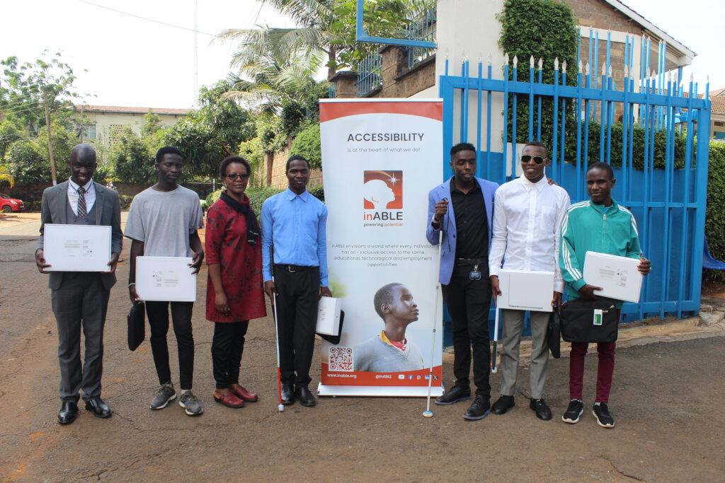 Beneficiaries posing with their Macbook laptops.