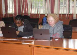 A picture of two ladies using Macbook laptops