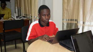 A picture of a man using a Macbook Laptop