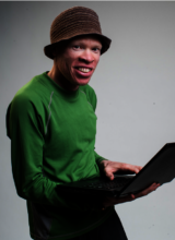 A picture of a man wearing a green shirt and dark