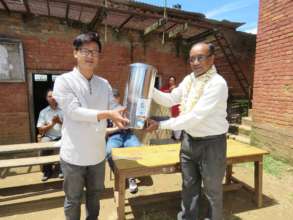 Handing over water filter to school representative