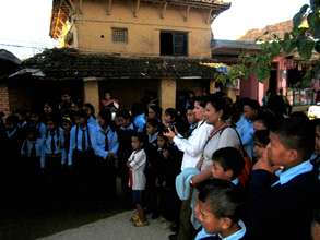 Students and locals gather to watch the drama.