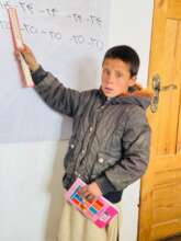Nasim, attending first grade in Ghore province