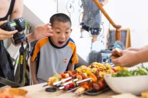 Kids faces at the meals they prepped