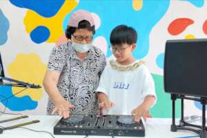 Youth with older friends DJ class