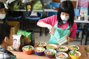 Kids prepping traditional noodles for lunch