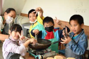 Kids cooking luncheon meat for sandwiches