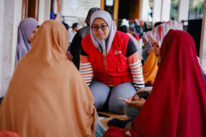 ActionAid staff interviews women for their needs.