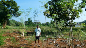 A farmer posing with his crops.