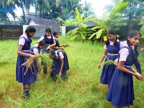 Girls clearing the soccer field