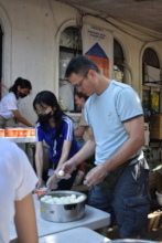 Tom, volunteer from China, help us prepare meals.