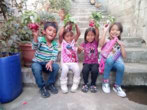 Students holding up their radishes