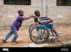 Disabled child being wheed fot treatment