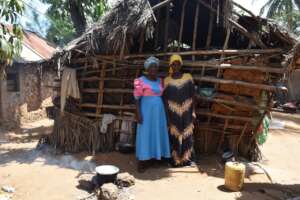 Halima's mum with a founder member at their home