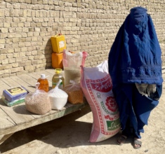 Afghan woman collecting her 100 kilos of food