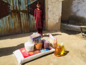 Afghan girl receiving the food supplies