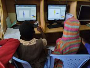 Girls trying out different things on the computers