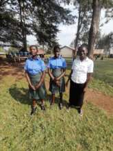 Two orphaned girls receiving their school uniforms