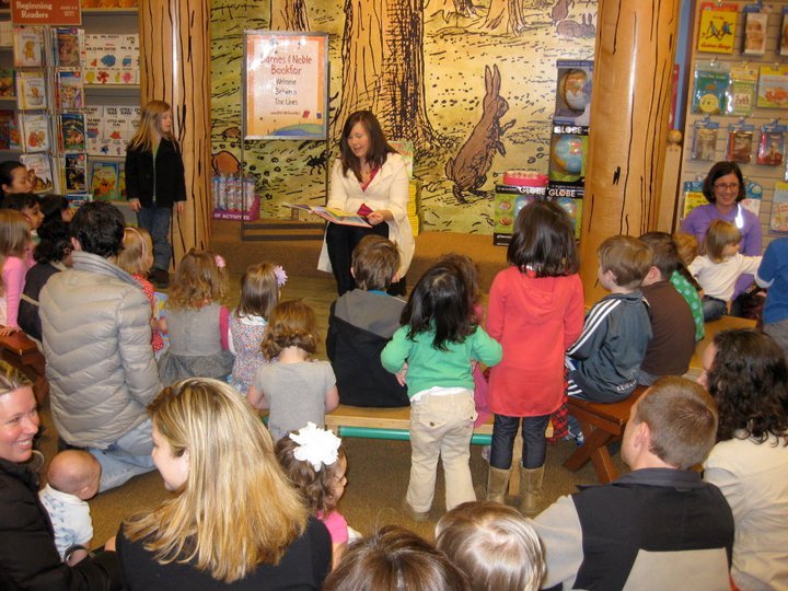 Junior League volunteer reading Pinkalicious