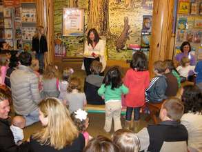 Junior League volunteer reading Pinkalicious