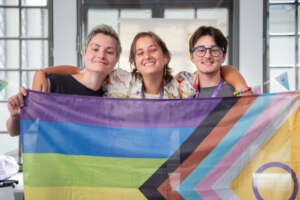 Participants posing with the Pride flag