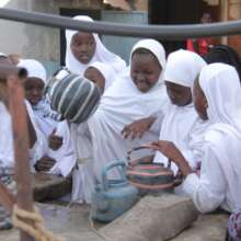girls uploading pots of water