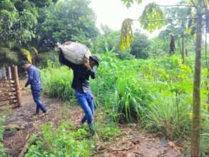Trainee collecting cow dung
