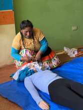 Promotora Ana Cecilia teaches neck stabilization
