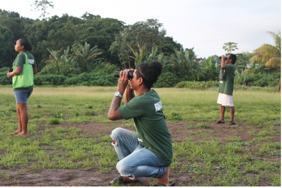 Rangers counting parrots from a local soccer field