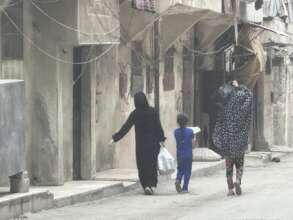 Mother and daughters with a monthly food basket