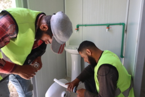 Construction work on a latrine unit in Syria