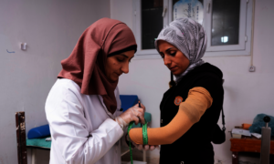 Fatma being fitted for her prosthetic hand