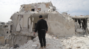 A man searches through the ruble in Syria