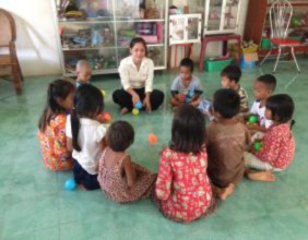 A counselor organizes group play for survivors