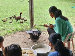 Bopha cooking for girls in the shelter