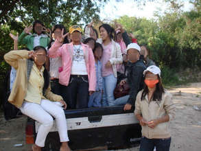 Pich (lower right) wears a mask to hide her mouth