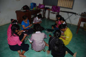 Girls in the shelter working on craft items