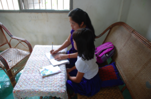 Vannit with the counselor working on homework.