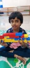 Isitha, enjoying playing with building blocks
