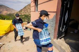 Peace Winds staff distribute water to survivors