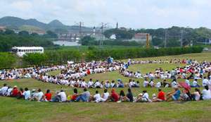 Hundreds of people gather along side Panama Canal