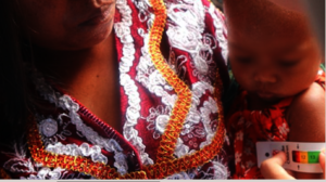 A mid upper arm circumference tape on a child