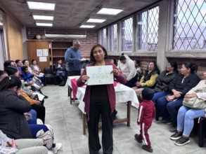 Mother Receiving Financial Education Certificate