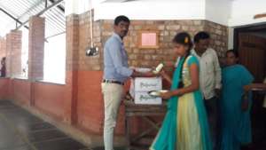 Donating a cold healthy drink to the children