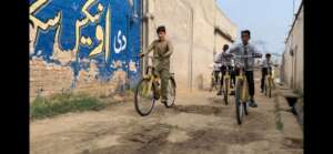 students taking a symbolic ride on the cycles