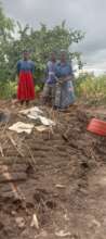 Orphans standing on top  of destroyed home