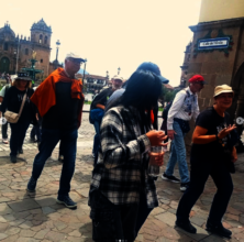 Tour group moves through Plaza des Armas in Cusco