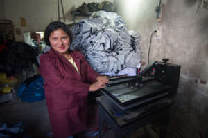 A clothing production student at the workshop